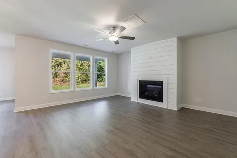 a large kitchen with a lot of cabinets and wooden floor