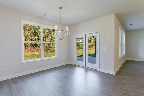 a view of a livingroom with a ceiling fan and window
