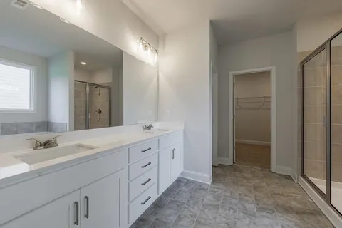 a bathroom with a sink toilet vanity and shower