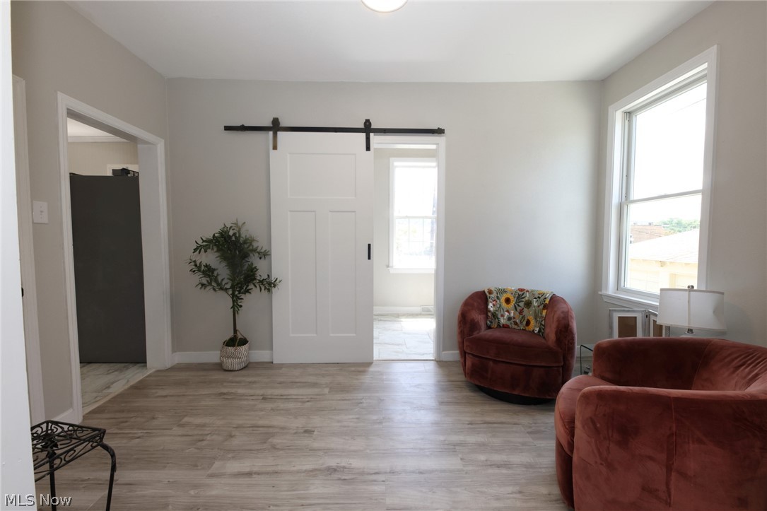 416 5th Street Chester, WV 26034 - Photo 8 of 24 Neutral wall paint and wood-finish flooring define this interior space