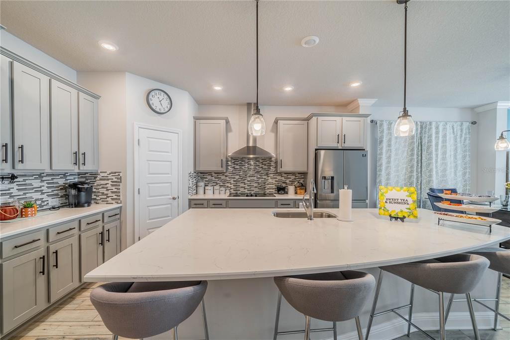 5538 Spanish Moss Cove Bradenton, FL 34203 - Photo 13 of 31 a kitchen with stainless steel appliances kitchen island granite countertop a sink and chairs