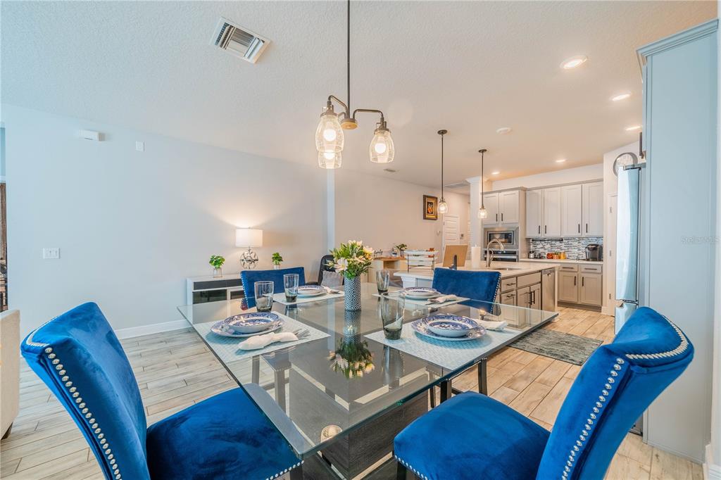 5538 Spanish Moss Cove Bradenton, FL 34203 - Photo 18 of 31 a view of a dining room with furniture a rug and wooden floor