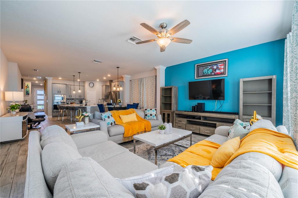 5538 Spanish Moss Cove Bradenton, FL 34203 - Photo 20 of 31 a living room with furniture kitchen view and a flat screen tv