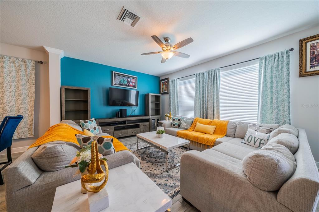5538 Spanish Moss Cove Bradenton, FL 34203 - Photo 21 of 31 a living room with furniture flat screen tv and a fireplace