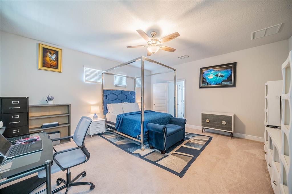 5538 Spanish Moss Cove Bradenton, FL 34203 - Photo 22 of 31 a living room with furniture a flat screen tv and a fireplace