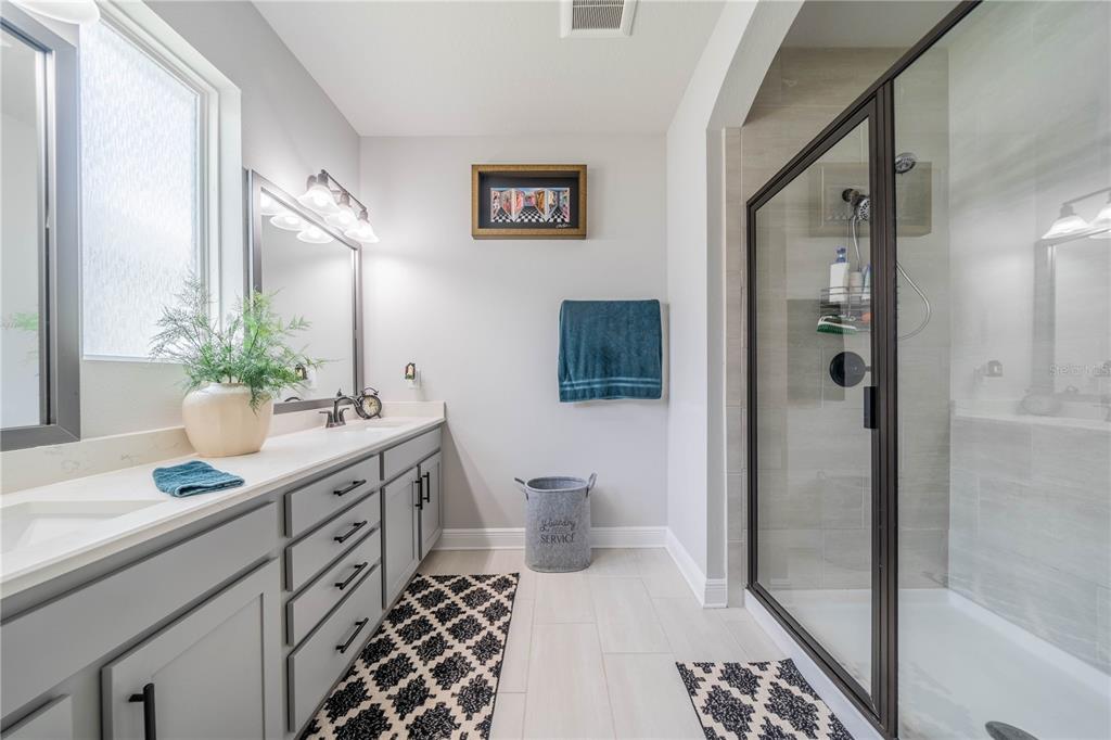 5538 Spanish Moss Cove Bradenton, FL 34203 - Photo 24 of 31 a bathroom with a sink a toilet and shower