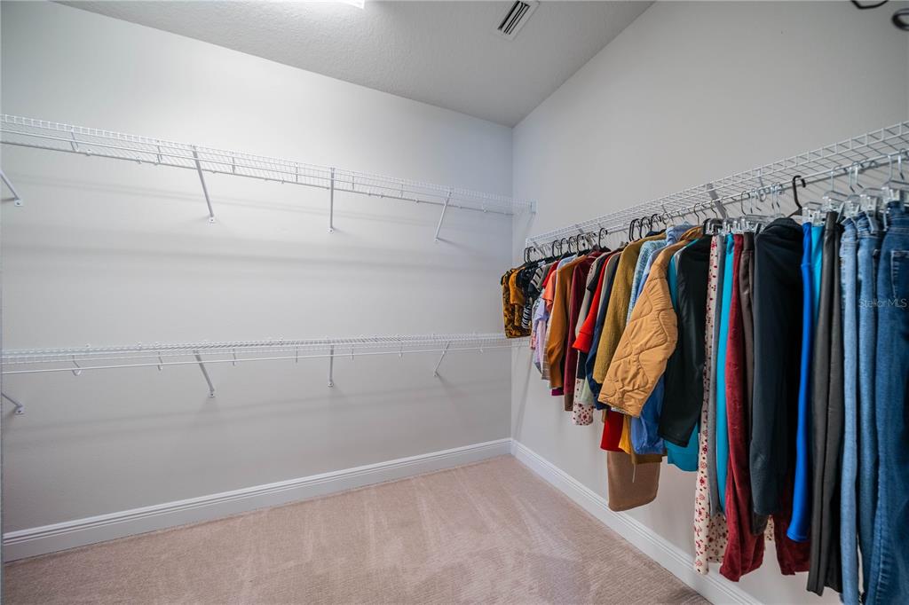 5538 Spanish Moss Cove Bradenton, FL 34203 - Photo 26 of 31 a view of walk in closet with clothes