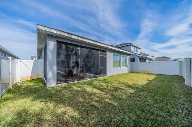 a dining room with furniture water view and a floor to ceiling window