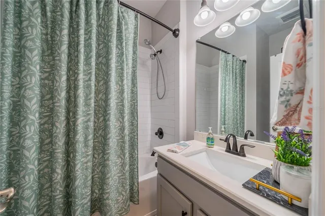 a bedroom with a bed table and a window