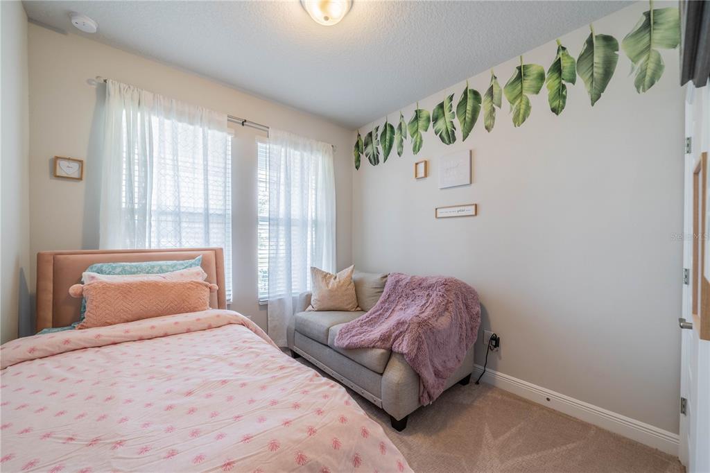 5538 Spanish Moss Cove Bradenton, FL 34203 - Photo 9 of 31 a bedroom with a bed table and a window