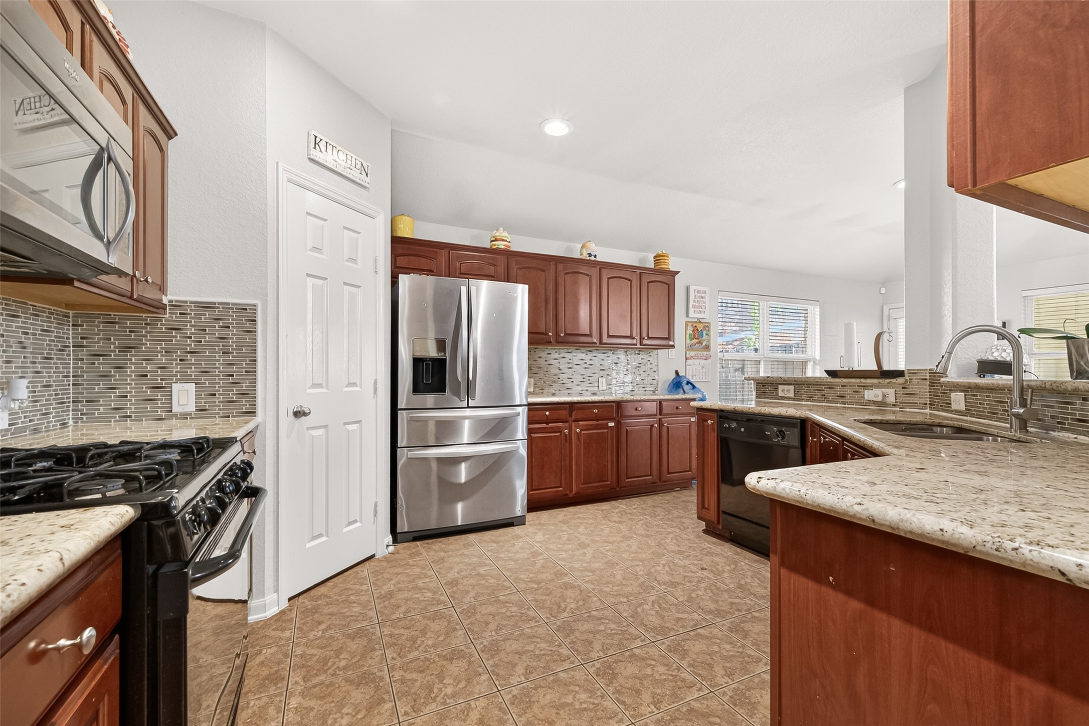 16715 Mackenzie Mesa Drive Spring, TX 77379 - Photo 12 of 50 a kitchen with stainless steel appliances and granite counter tops