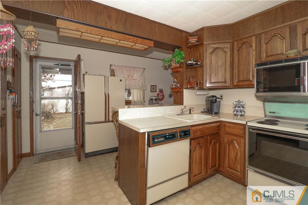 38 Gurley Road Edison, NJ 08817 - Photo 11 of 25 a kitchen with a sink and stainless steel appliances