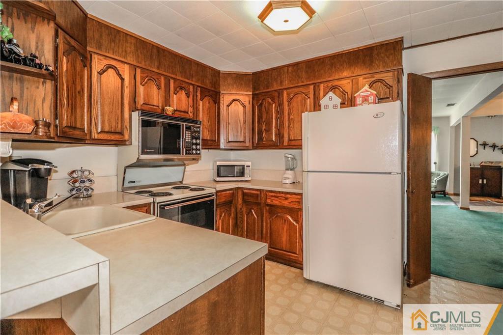 38 Gurley Road Edison, NJ 08817 - Photo 12 of 25 a kitchen with stainless steel appliances a refrigerator sink and microwave