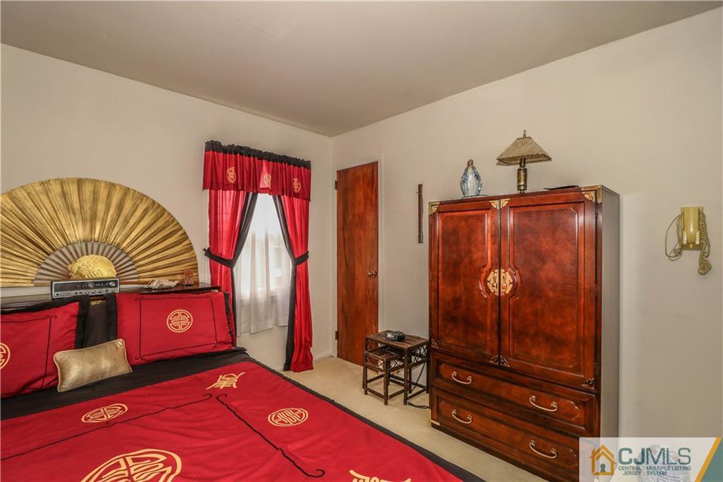 38 Gurley Road Edison, NJ 08817 - Photo 16 of 25 a bedroom with a bed and a dresser