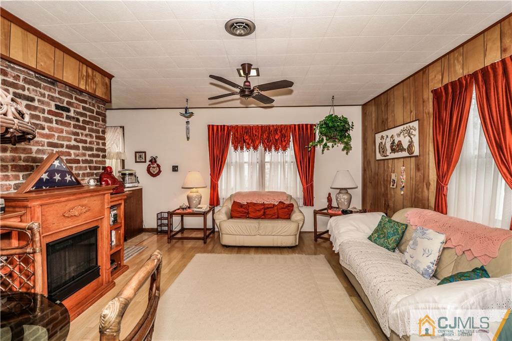 38 Gurley Road Edison, NJ 08817 - Photo 22 of 25 a living room with furniture a fireplace and a flat screen tv