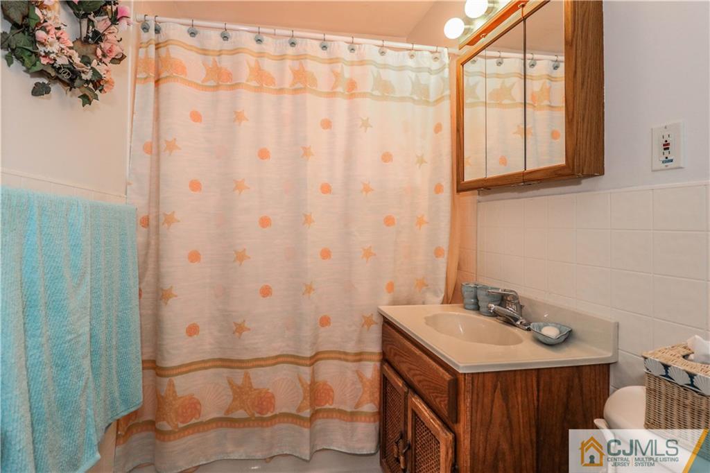 38 Gurley Road Edison, NJ 08817 - Photo 23 of 25 a bathroom with a sink and a mirror