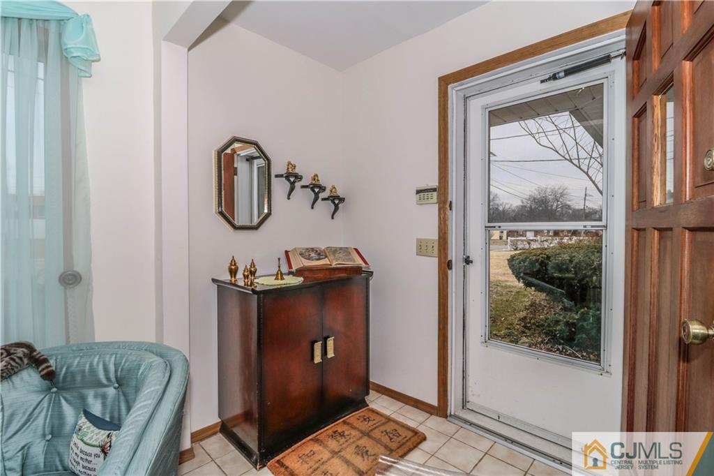 38 Gurley Road Edison, NJ 08817 - Photo 4 of 25 a living room with a couch and a table