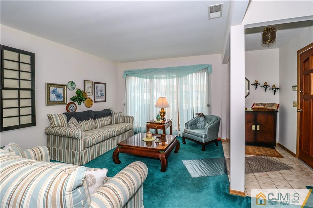 38 Gurley Road Edison, NJ 08817 - Photo 6 of 25 a living room with furniture and a fireplace
