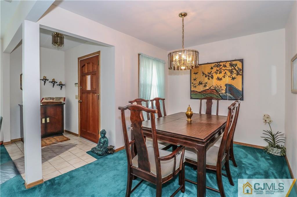 38 Gurley Road Edison, NJ 08817 - Photo 9 of 25 a dining room with furniture a chandelier and wooden floor