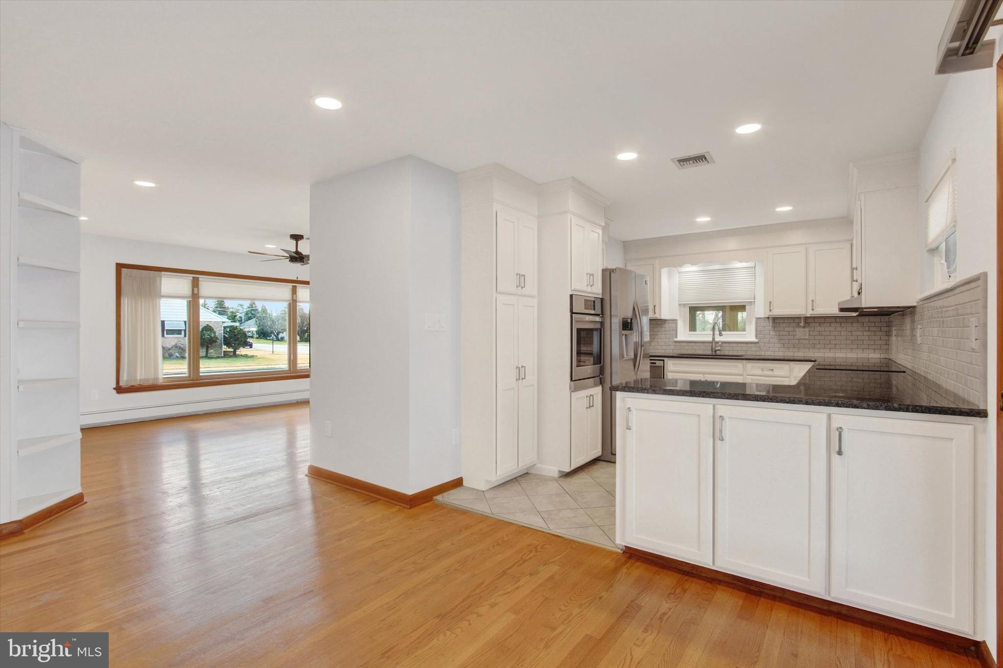 200 Sunset Avenue Hanover, PA 17331 - Photo 8 of 28 a kitchen with stainless steel appliances granite countertop a refrigerator a sink and a stove with wooden floor