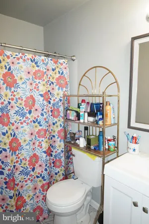 a bathroom with a sink mirror vanity and toilet