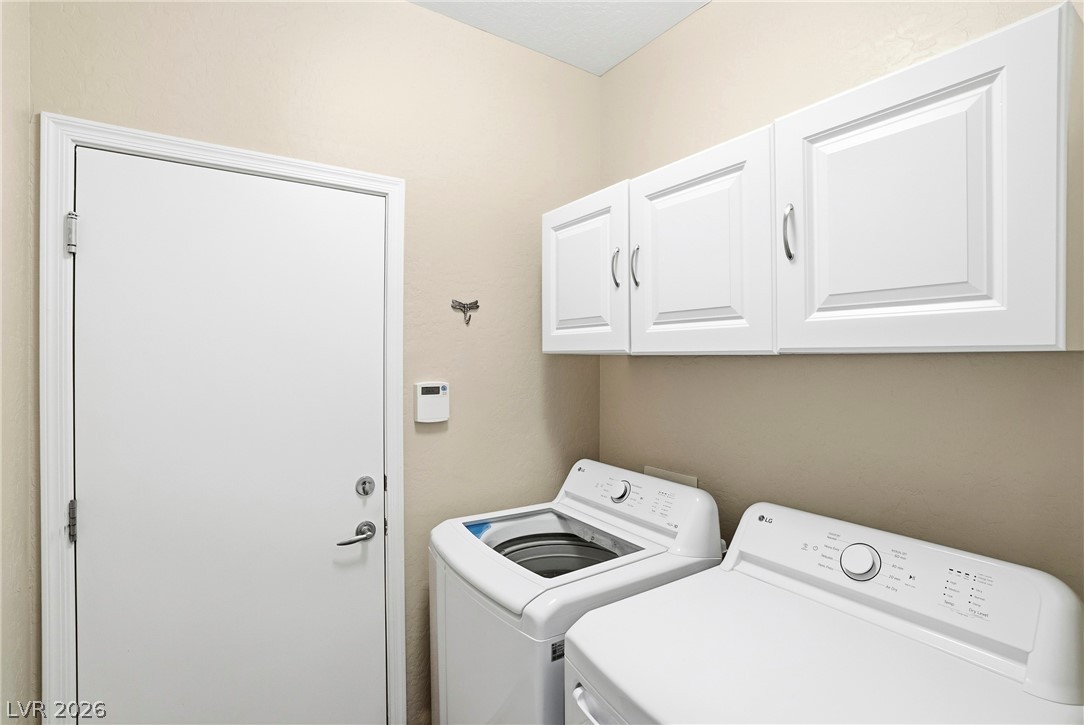 2541 Darda Street Henderson, NV 89044 - Photo 14 of 26 This dedicated laundry room includes modern appliances and convenient storage solutions.