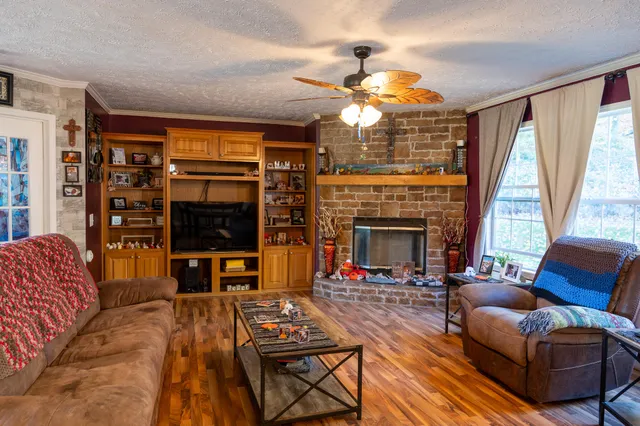 a living room with furniture a flat screen tv and a fireplace