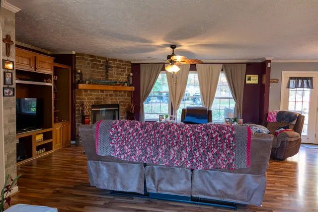 a living room with furniture fireplace and flat screen tv