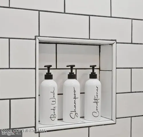 a bathroom with a granite countertop sink a mirror and shower