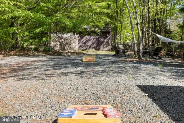 a view of a chairs and table in backyard