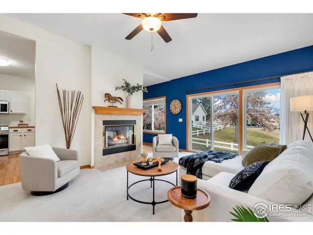 a living room with furniture a fireplace and a chandelier