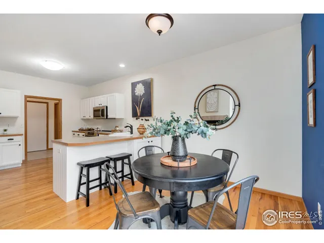 a kitchen with stainless steel appliances a dining table and chairs