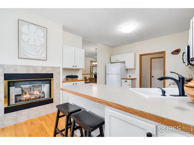 a kitchen with furniture and a fireplace