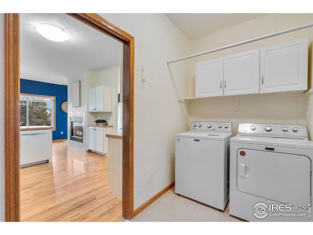 a view of washer and dryer with kitchen view