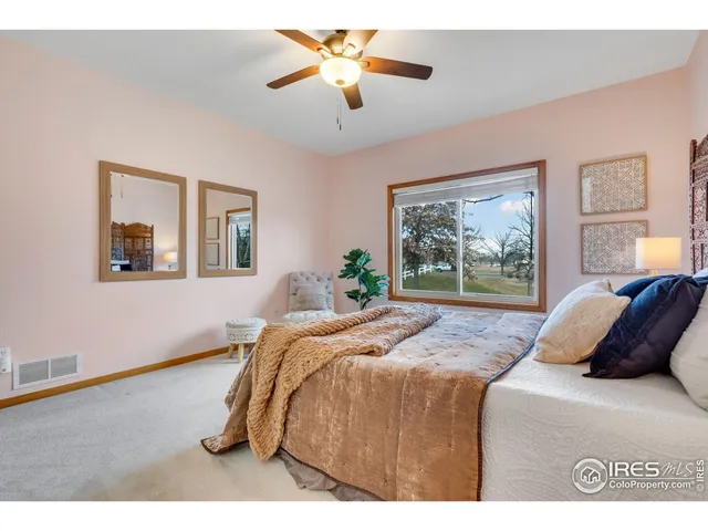 a bedroom with a bed and a painting on the wall