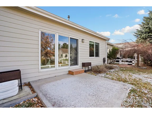a backyard of a house with yard and outdoor seating