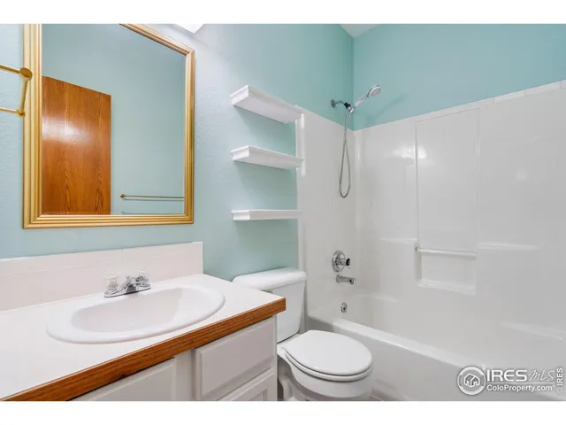 a bathroom with a sink toilet a mirror and shower