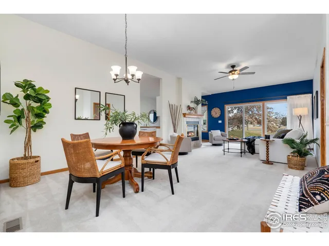 a dining room with furniture a livingroom and chandelier