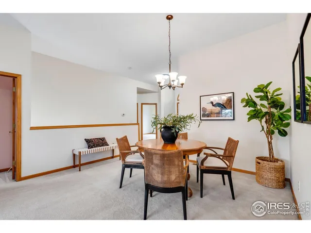 a view of a dining room with furniture a chandelier and wooden floor