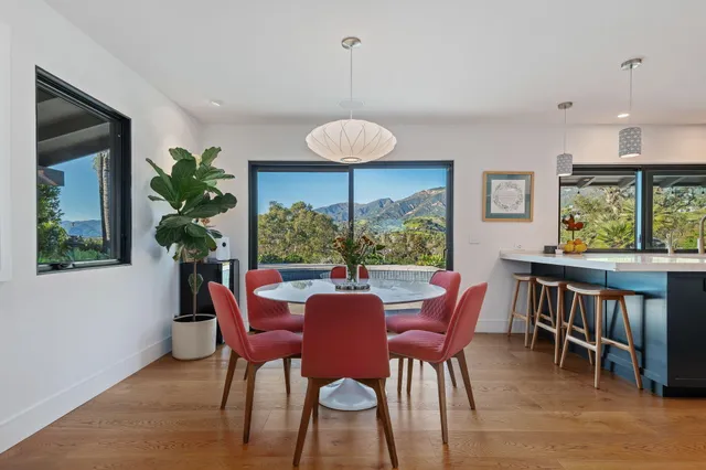 a view of a dining room with furniture window and wooden floor