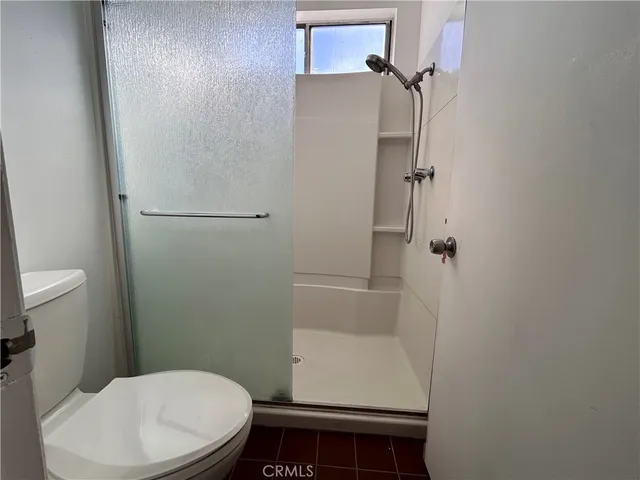 a bathroom with a toilet and a shower