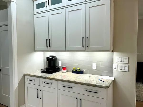 a kitchen with granite countertop cabinets and white appliances