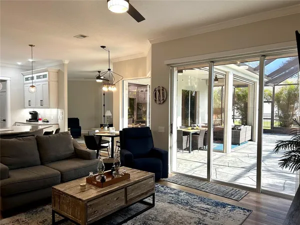 a living room with furniture and a chandelier