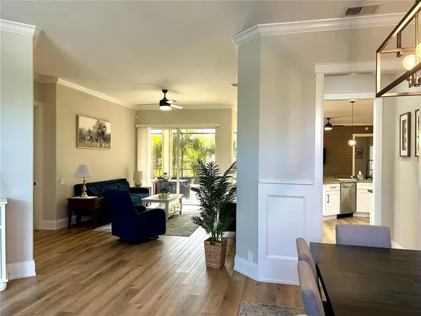a living room with furniture or wooden floor and a large window