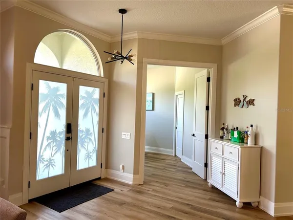 a view of a room with wooden floor and windows