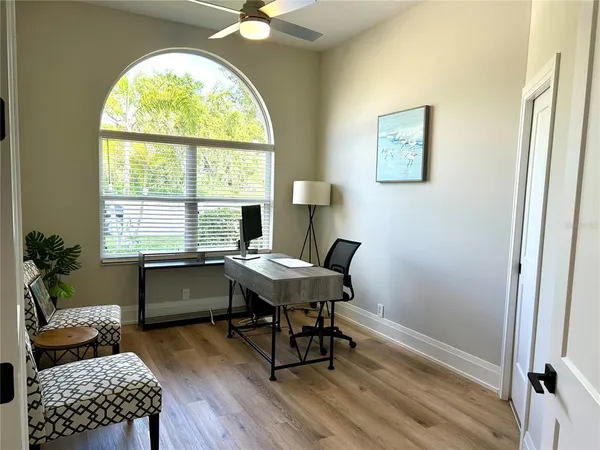 a view of a workspace with furniture and a window
