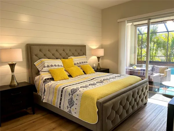 a bedroom with bed and wooden floor