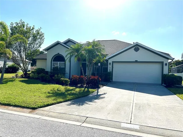 a front view of a house with a garden and plants