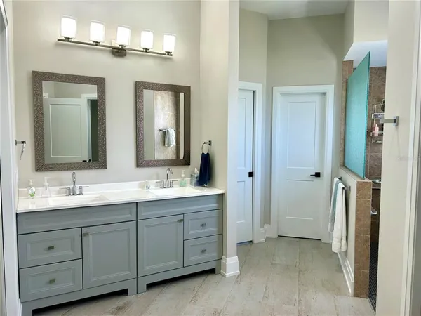 a bathroom with a double vanity sink and a mirror