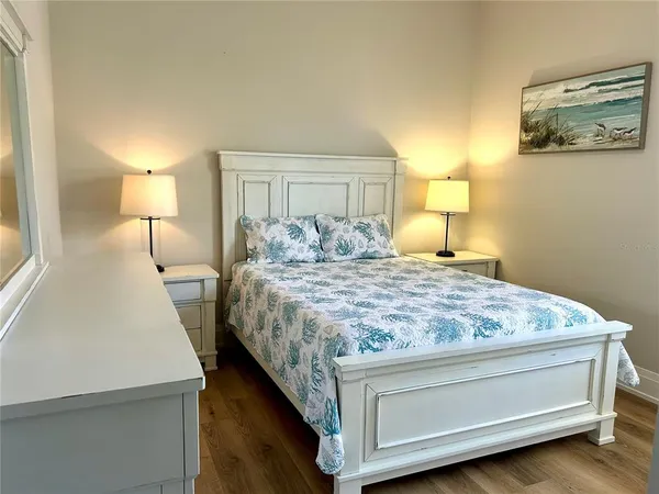 a bedroom with a bed and a night stand